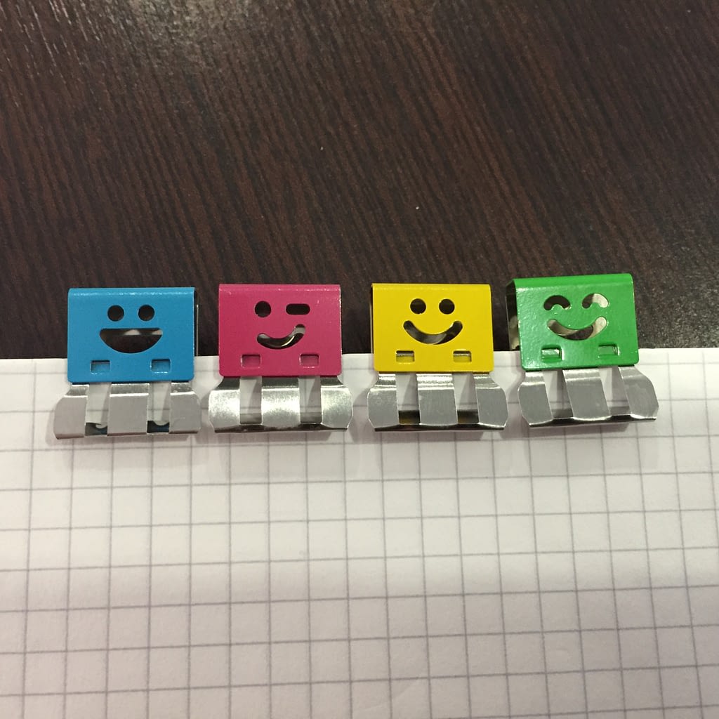 Colourful paperclips with cheerful expressions